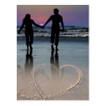 Amants tenant des mains entrant dans le coucher du carte postale