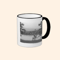 Bétail par un étang avec deux cowboys tasses
