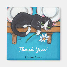 Chat tenant un aimant de Merci de la marguerite |