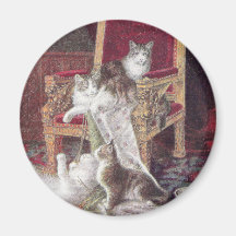 Chats jouant sur le cru rouge de chaise de velours magnets pour réfrigérateur
