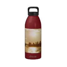 Coucher du soleil de paysage urbain au-dessus de l bouteilles d'eau réutilisables