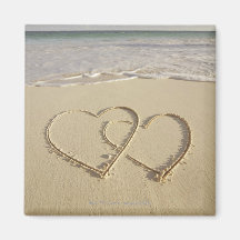 Deux coeurs sus-jacents dessinés sur la plage magnets