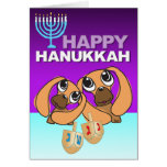 Le chiot heureux de carte de Hanoukka joue Dreidel