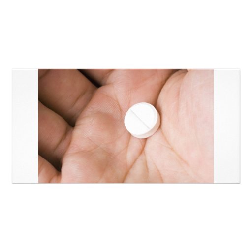 Pilule blanche simple dans la paume cartes avec photo