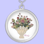 Vase avec les roses roses colliers