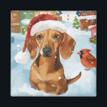 Aimant Dachshund Winter Wonderland Christmas Joy<br><div class="desc">Ce design festif reflète l'esprit joyeux de la période des fêtes, avec un adorable petit portant un chapeau de Père Noël. Le chien est niché dans un pays des merveilles hivernales, avec un bonhomme de neige, un sapin de Noël décoré et des cadeaux joliment emballés. Les flocons de neige tombent...</div>