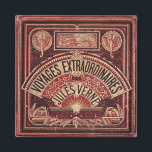 AIMANT JULES VERNE "VOYAGES EXTRAORDINAIRES" (1878)<br><div class="desc">Created from the precious original 1878 book cover. Beautiful etching in gold an crimson. A precious gift for yourself or someone you love !</div>