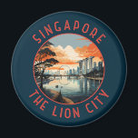 Aimant Singapore Retro Distressed Circle<br><div class="desc">Modèle de voyage vectoriel rétro de Singapour. Marina Bay est un quartier haut de gamme de gratte-ciel,  d'hôtels chics et de centres commerciaux de luxe. Elle est connue pour la grande roue Singapore Flyer Ferris et les conservatoires de fleurs et les superarbres colorés des jardins de la baie.</div>