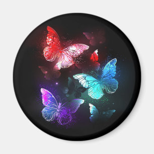 Aimant Trois papillons lumineux sur fond de nuit