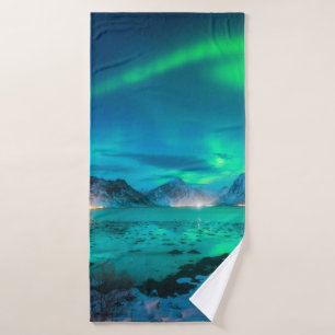 Aurora borealis over the sea coast, snowy mountain