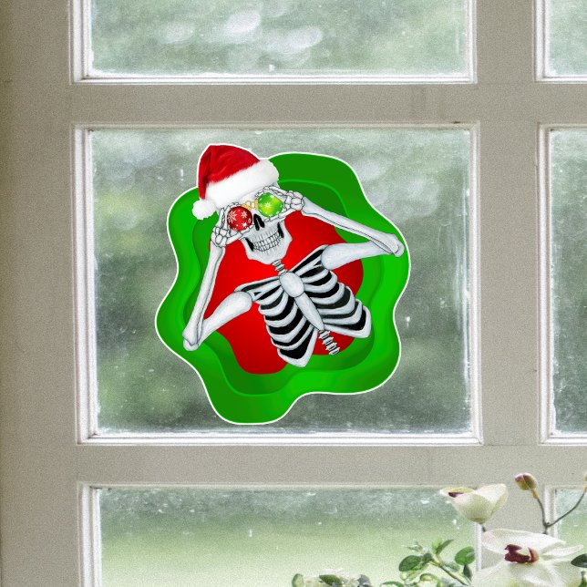 Autocollant Pour Fenêtre Squelette De Noël Amusant En Forme D'Ardoise (Fun skeleton Santa Hat holding ornaments in green red spatter on window cling Christmas Decoration.)