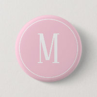 Bouton rond monogramme blanc sur fond rose clair