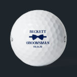 Balles De Golf Groomsman Blue Bow Tie<br><div class="desc">These golf balls are a great favor for the groomsman in your wedding. They feature a blue bow tie with the groomsman's name above it in a modern CAP font and the word Groomsman along with the wedding date below. They'd be great for a bachelor party or weekend. The job...</div>