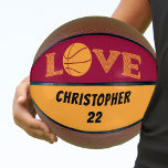 Ballon De Basket LOVE Maroon rouge et jaune doré Personnalisé<br><div class="desc">Basket-ball personnalisé de taille réelle en rouge marron et jaune doré. Le design comporte le mot "LOVE" écrit en typographie de chevron avec un ballon de basket pour la lettre "O". Le modèle est configuré pour que vous puissiez ajouter votre nom et votre numéro de maillot ou du texte personnalisé....</div>