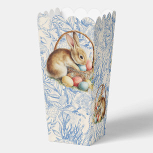 Ballotins Pâques, lapins et œufs colorés dans un panier en o