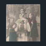 Bloc-note Photo de Christmas Girls et Snowman Vintage<br><div class="desc">A charming antique 1910 French Christmas photo postcard of two pretty,  adorable little girls happily hugging and posing with their solive snowman friend,  as snow flow down upon them. Wishing a Joyeux Noel.</div>