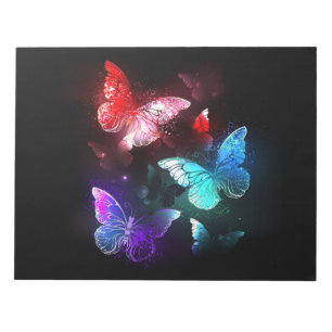 Bloc-note Trois papillons brillants sur l'arrière - plan de