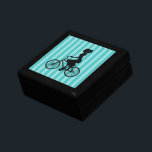 Boîte À Souvenirs Silhouette cycliste pour fille rétro<br><div class="desc">Une jolie illustration graphique rétro. Une silhouette d'une femme en queue de cheval,  portant une robe et faisant du vélo. L'arrière - plan est une motif rayée bleu turquoise avec alternance de tons clairs et sombres.</div>