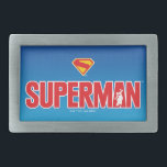 Boucle De Ceinture Rectangulaire Logo classique Superman Bold<br><div class="desc">Apportez une énergie super-héros intemporelle à votre style avec ce design Superman saisissant! Avec le texte rouge "SUPERMAN" gras avec une silhouette de l'Homme de l'Acier héroïquement posée dans le lettrage, cette oeuvre apparaît contre un arrière - plan bleu dégradé élégant. Coincé avec l’emblématique bouclier rouge et jaune "S", c’est...</div>