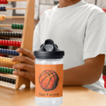 Bouteille D'eau Basket-ball artistique Sport Nom personnalisé<br><div class="desc">Présentation de la bouteille d'eau "Artistic Basketball Sport Custom Name", le compagnon idéal d'hydratation pour les amateurs de basketball et les aspirants athlètes! Cette bouteille d'eau vibrante présente un ballon de basket artistique dessiné à la main contre un arrière - plan orange dynamique. L'illustration détaillée crée un design énergique et...</div>