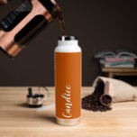 Bouteille D'eau Burange Orange Mariage personnalisé Bridesmaid<br><div class="desc">Offrez à votre femme de chambre ou à votre femme d'honneur cette bouteille d'eau isolée à la mode et sous vide qui porte son nom en blanc, stylisé sur un arrière - plan couleur orange brûlé conçu pour correspondre à votre schéma de couleurs mariages. Personnalisez la bouteille en modifiant et...</div>