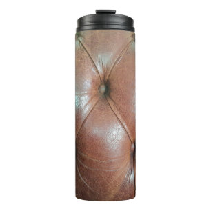 Bouteilles Isothermes Lumière sur la surface du canapé en cuir marron, t