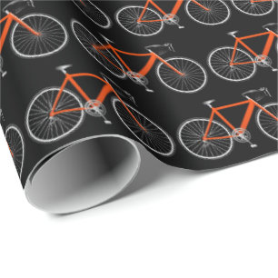 Cadeau bicyclette orange sur papier d'emballage noir