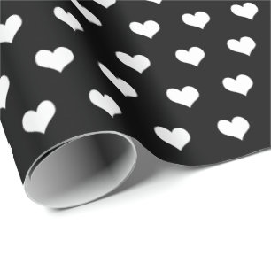 Cadeau coeurs blancs sur papier d'emballage noir