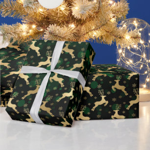 Cadeau Renne de Noël en faux papier d'or et bokeh vert