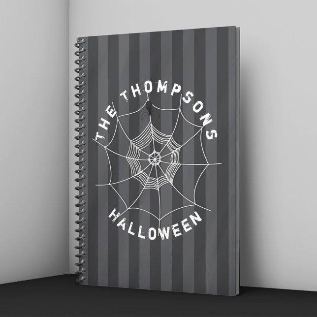 Cahier de Halloween à toile d'araignée personnalis (Personalized Halloween notebook with spider web and spider on dark striped background.)