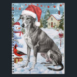 Carnet Greyhound Winter Wonderland Christmas Joie<br><div class="desc">Ce design festif reflète l'esprit joyeux de la période des fêtes, avec un adorable petit portant un chapeau de Père Noël. Le chien est niché dans un pays des merveilles hivernales, avec un bonhomme de neige, un sapin de Noël décoré et des cadeaux joliment emballés. Les flocons de neige tombent...</div>