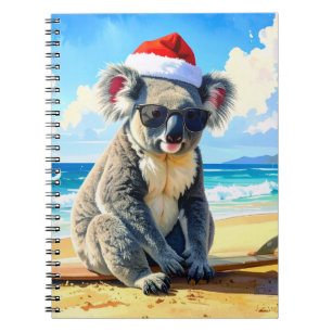 Carnet Koala avec un chapeau de Père Noël profitant du so