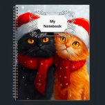 Carnet Meowy Christmas Winter Love<br><div class="desc">Une scène fantaisiste et festive pleine de joie et d'amour pour un chat noir heureux et un chat orange, tous deux portant des chapeaux de Père Noël, entourés de chutes de flocons de neige.</div>