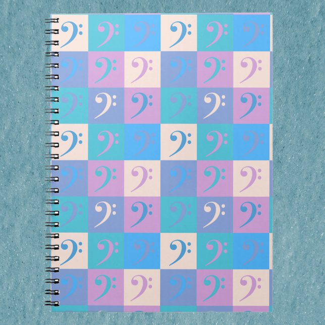 Carnet Motif de clé de fa pastel (A notebook with a pattern of bass clef music symbols in blue, yellow, pink and purple.)