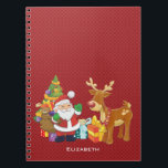 Carnet Santa and Reindeer par Christmas Tree with Present<br><div class="desc">Une jolie illustration avec l'esprit de fête. Le Père Noël portant son sac cadeau et saluant. Son ami renne à ses côtés, suspendu par un sapin décoré, avec des cadeaux tout autour. Placez-vous sur un arrière - plan rouge avec des cercles fantaisistes. Design festif et gai. Personnalisez avec un nom...</div>