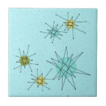 Carreau de céramique atomique bleu de Starbursts<br><div class="desc">Le motif atomique iconique bleu de carreau de céramique de Starbursts des oeufs de ce Robin comporte les starbursts atomiques iconiques. C'est exact ! La vieille école, arrière - plan coloré par bleu des oeufs du merle avec des taches d'or est le contexte parfait pour la turquoise vibrante, le céleri...</div>
