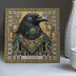 Carreau Mystical Raven Spirit Personnalisé Tribal<br><div class="desc">Embarquez pour un voyage mystique avec notre tuile en céramique "Mystical Raven Spirit". Le design présente un majestueux Corbeau, resplendissant de bijoux tribaux, capturé en parfaite harmonie symétrique. Les couleurs sont riches et réconfortantes, avec des tons vert foncé, marron, or et aquamarine foncée, et elles donnent l'impression d'être un retable...</div>