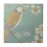 Carreau Oiseau jaune, gris et beige perché sur une branche<br><div class="desc">Chariklia Zarris est connue pour ses oeuvres d'art abstraites. Dans ce dessin d'un profil d'oiseau sur un arrière - plan turquoise bleu,  elle saisit la simplicité de l'oiseau. Les fleurs blanches apportent une touche romantique. Customisez votre produit Zazzle préféré en utilisant cette belle image.</div>