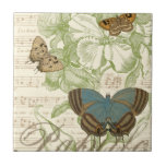 Carreau Papillons sur Partition avec Design Floral<br><div class="desc">Un design floral vert et de la partition font arrière - plan à un trio de papillons dans cette pièce de Vision Studio. Le mot français papillon est également emblaqué au fond de la pièce. Si vous aimez les papillons, la nature, ou tout comme vous entourer de beauté, c'est l'impression...</div>