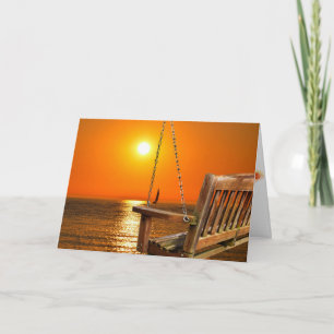 Carte balançoire en bois avec coucher de soleil sur le l