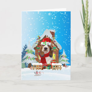 Carte Basset Hound dans la neige avec des cadeaux de Noë