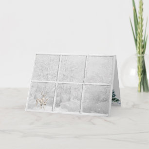 Carte Cerf d'hiver de Noël dans la fenêtre