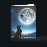 Carte Chien observant le Père Noël et Reindeer<br><div class="desc">Un chien berger allemand regarde vers la pleine lune où le traîneau à Père Noël et les rennes sont silhoués contre une pleine lune brillante</div>