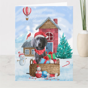 Carte Chien Weimaraner dans une maison de Noël enneigée
