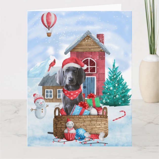 Carte Chien Weimaraner dans une maison de Noël enneigée (Devant)
