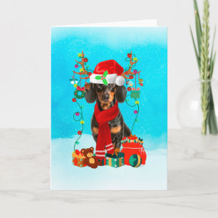 Carte Dachshund dans la neige avec cadeaux de Noël