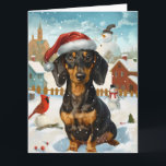 Carte Dachshund Winter Wonderland Christmas Joy<br><div class="desc">Ce design festif reflète l'esprit joyeux de la période des fêtes, avec un adorable petit portant un chapeau de Père Noël. Le chien est niché dans un pays des merveilles hivernales, avec un bonhomme de neige, un sapin de Noël décoré et des cadeaux joliment emballés. Les flocons de neige tombent...</div>
