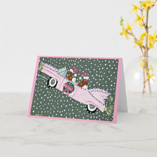 Carte Dachshunds à Noël dans une décapotable rose (Fleur jaune)