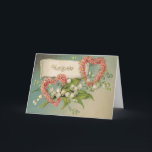Carte d'anniversaire avec les coeurs et le muguet<br><div class="desc">Cette belle carte de voeux a été créée utilisant une carte postale 1900's victorienne antique tôt. Elle comporte les lis blancs de la vallée,  des fleurs roses sous forme de deux coeurs et du message simple "joyeux anniversaire." Ajoutez votre propre message sur l'intérieur,  ou laissez-le vide. Vous décidez !</div>