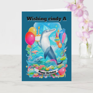 Carte Dauphin Portant un casquette d'anniversaire tenant
